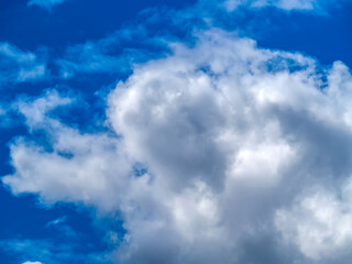 Dence cumulonimbus clouds over the blue sky.