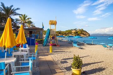 Cavo, Island of Elba Province of Livorno Italy - 20 September 2021 beach bar and pebble beach on sunny day