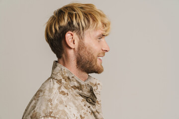 Fototapeta premium White military man wearing uniform smiling and looking aside