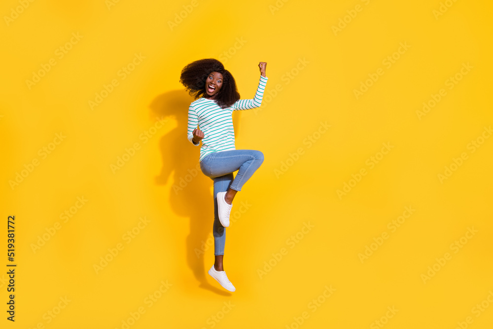Wall mural Full size photo of overjoyed satisfied person jumping raise fists celebrate luck isolated on yellow color background - Wall murals