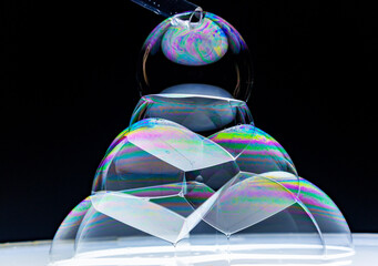 soap bubbles piled up in a pyramid shape - obrazy, fototapety, plakaty
