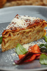 Homemade delicious Meat lasagna with basil leaf on the top. Close up. Recipe, menu. Italian cuisine. Side view