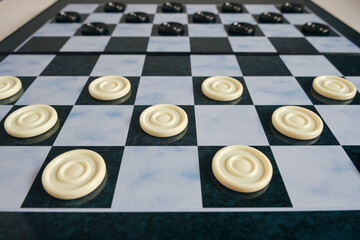 Background, checkers board with checkers, checkers is logical game for two.