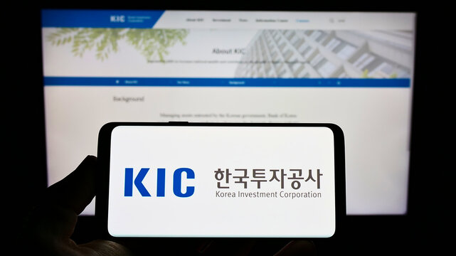 Stuttgart, Germany - 01-08-2022: Person holding mobile phone with logo of fund Korea Investment Corporation (KIC) on screen in front of company web page. Focus on phone display.