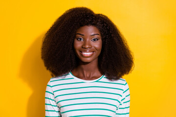 Photo of gorgeous positive lady curly hairstyle toothy beaming smile isolated on yellow color background
