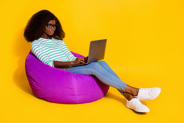 Full size photo of attractive lady sitting bag use wireless netbook coworking isolated on yellow color background