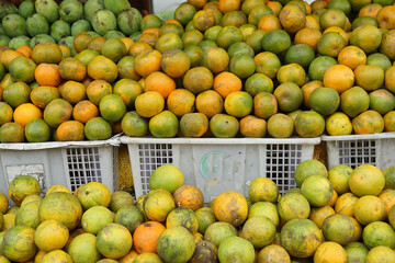 oranges and neat arrangement of fruit in baskets at the traditional market. healthy and fresh orange fruit background