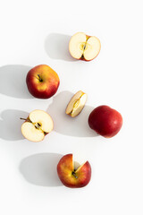Whole, halves and cut apples on a white background. Top view, flat lay