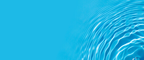Bursts on blue water under sunlight. Top view, flat lay. Banner