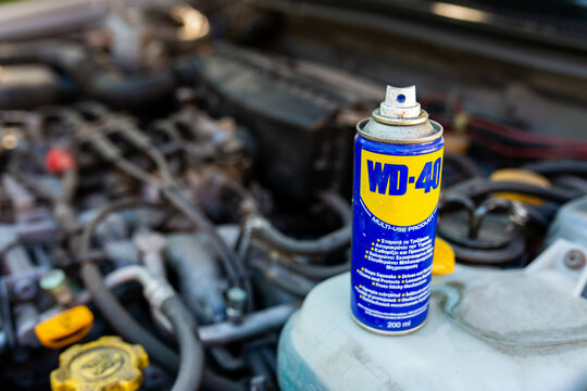 Miercurea Ciuc, Romania- 26 July 2022: WD-40 multi purpose penetrating oil on old japanese car engine, space for text.