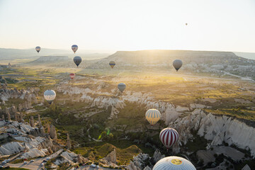 Sunrise landscape in Cappadocia, with all the hot air balloons flying, aerial views from another balloon