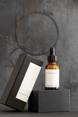 Brown glass dropper bottle  and packaging box a black background. perfect inage for Mock up...