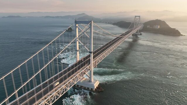 Rotating around suspension bridge with light traffic over strong current