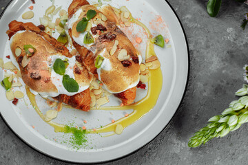 croissant with sweet cream and almonds on a plate. Delicious and healthy breakfast