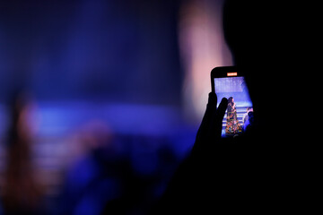 Photo smartphone a concert program in the theater hall. Blur texture, photo defocus, background for...