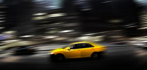 Fototapeta na wymiar Taxi at Night in Busy City Street Dark Fast Driving Transportation Selective Color