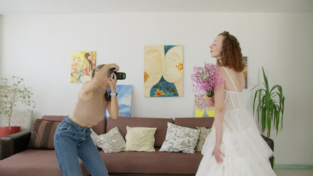 4K. A young bride is photographed by a photographer