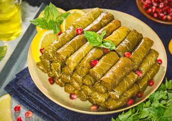 Arabic Cuisine; Traditional Lebanese stuffed vine leaves. Served with olive oil, pomegranate, fresh...