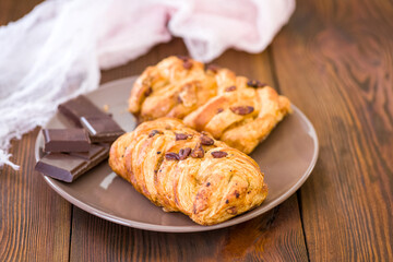 puff pastry biscuit with peaches and a cube of chocolate