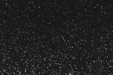 Gray black sparkling glitter background, christmas abstract shiny texture. Holiday bokeh lights. Snowy sparkle stars for celebrate