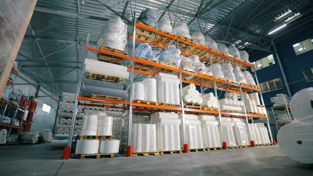 Lots of big rolls of spunbond. Warehouse with rolls of nonwovens. Large warehouse in the nonwovens factory. industrial interior