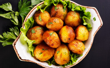 delicious baked potatoes on a dark background