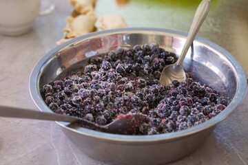 Blueberries for dumplings. Sprinkled with sugar. Close-up.