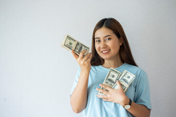 Excited Asian woman with rich and rich holding dollar bills income and salary concept