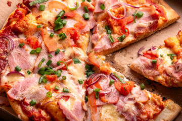 Pizza with Bacon, melted cheese, tomatoes, onion and spring onions