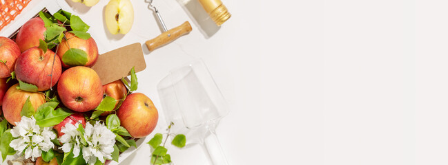 Food banner with farm apples, bottle of apple cider, glass and corkscrew on white background with...
