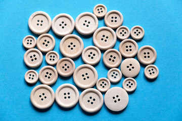 Different wooden buttons on a blue background. Button background