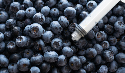 syringe and blueberry, biohazard liquid © Angelov