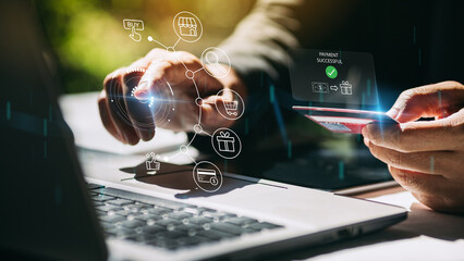 Businessman with notebook computer paying online shopping on virtual tech with credit card. Online...