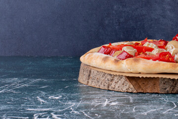 Traditional Italian Pizza with mozzarella, tomatoes and salami over black background, copy space. Delivery pizza or pizzeria promotional concept, Pizza Margherita, top view Pizza Margarita with Tomato