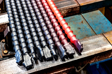 A metal rod heated in an induction furnace after processing. Hot metal cools down. Metalworking in...