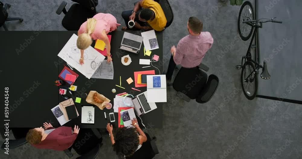 Poster engineers brainstorming ideas for a product from above in a trendy office. overhead of a diverse tea