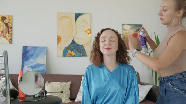 4K. The bride is getting ready for the wedding. A girl gets her hair done