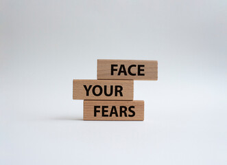 Face your Fears symbol. Wooden blocks with words Face your Fears. Beautiful white background. Business and Face your Fears. Copy space.