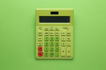 Modern calculator on green background, top view - obrazy, fototapety, plakaty