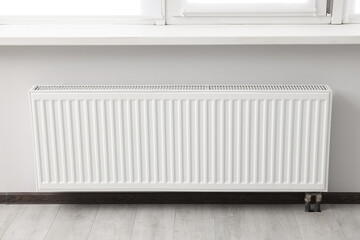 Modern radiator in room. Central heating system