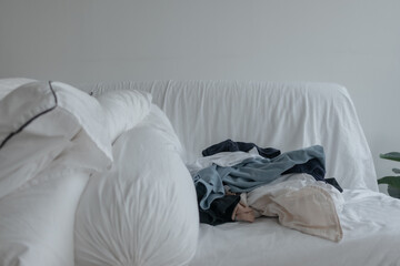 Washed clothes on the sofa ready to be fold and organized concept of house work.