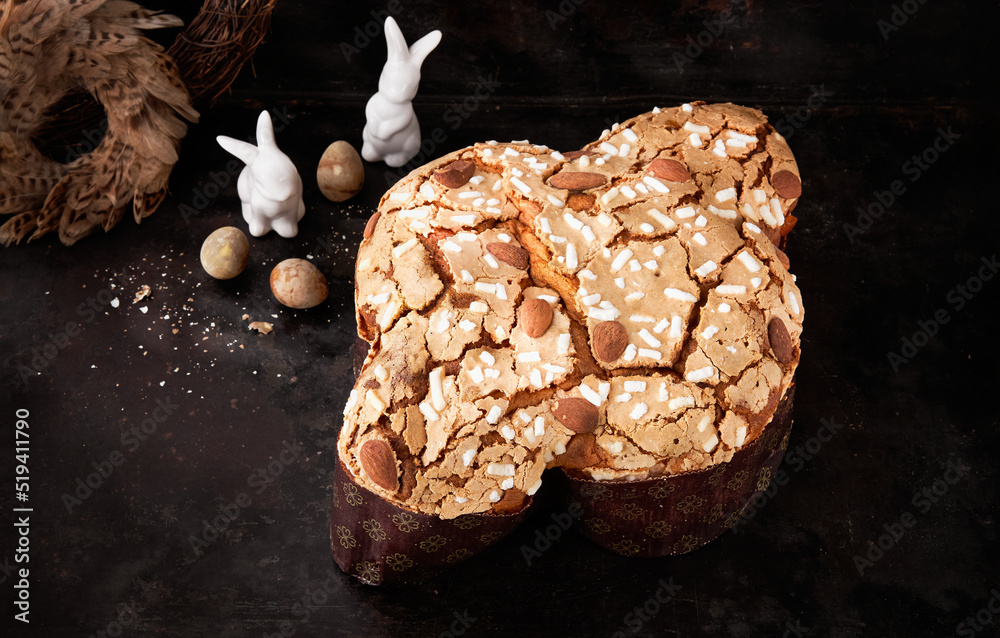 Wall mural Colomba Pasquale, Italian Easter Dove Sweet Bread Colomba di Pasqua on dark surface. Selective focus, space for text. Traditional dessert in Italy.