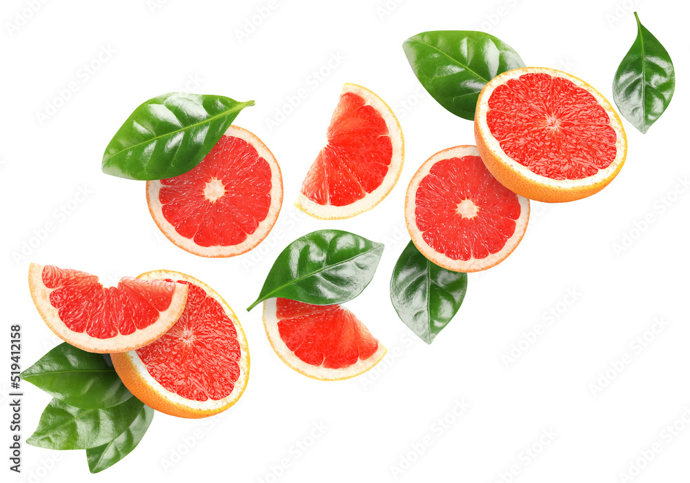 Wall mural tasty ripe grapefruits and green leaves falling on white background