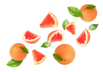 Tasty ripe grapefruits and green leaves falling on white background