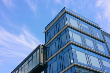 Low angle view of modern buildings against blue sky - Powered by Adobe