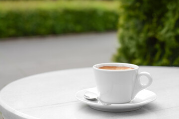Ceramic cup of aromatic coffee on table in morning, space for text