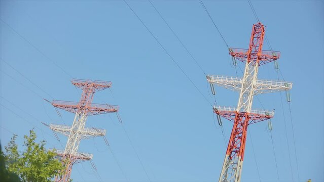 Modern high voltage tower. Power line against the blue sky. High Voltage Transmission Tower. Electrical Transmission Tower against the blue sky.