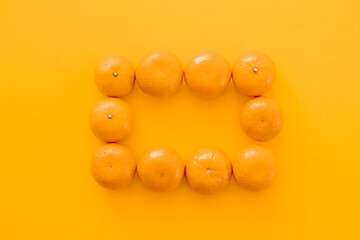 Tasty juicy tangerines on yellow background