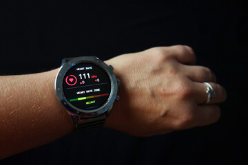 smartwatch on person hand show weather, pulse, heart beat, blood pressure