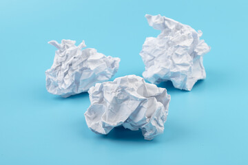 Fototapeta premium A piece of crumpled white paper on a blue background.